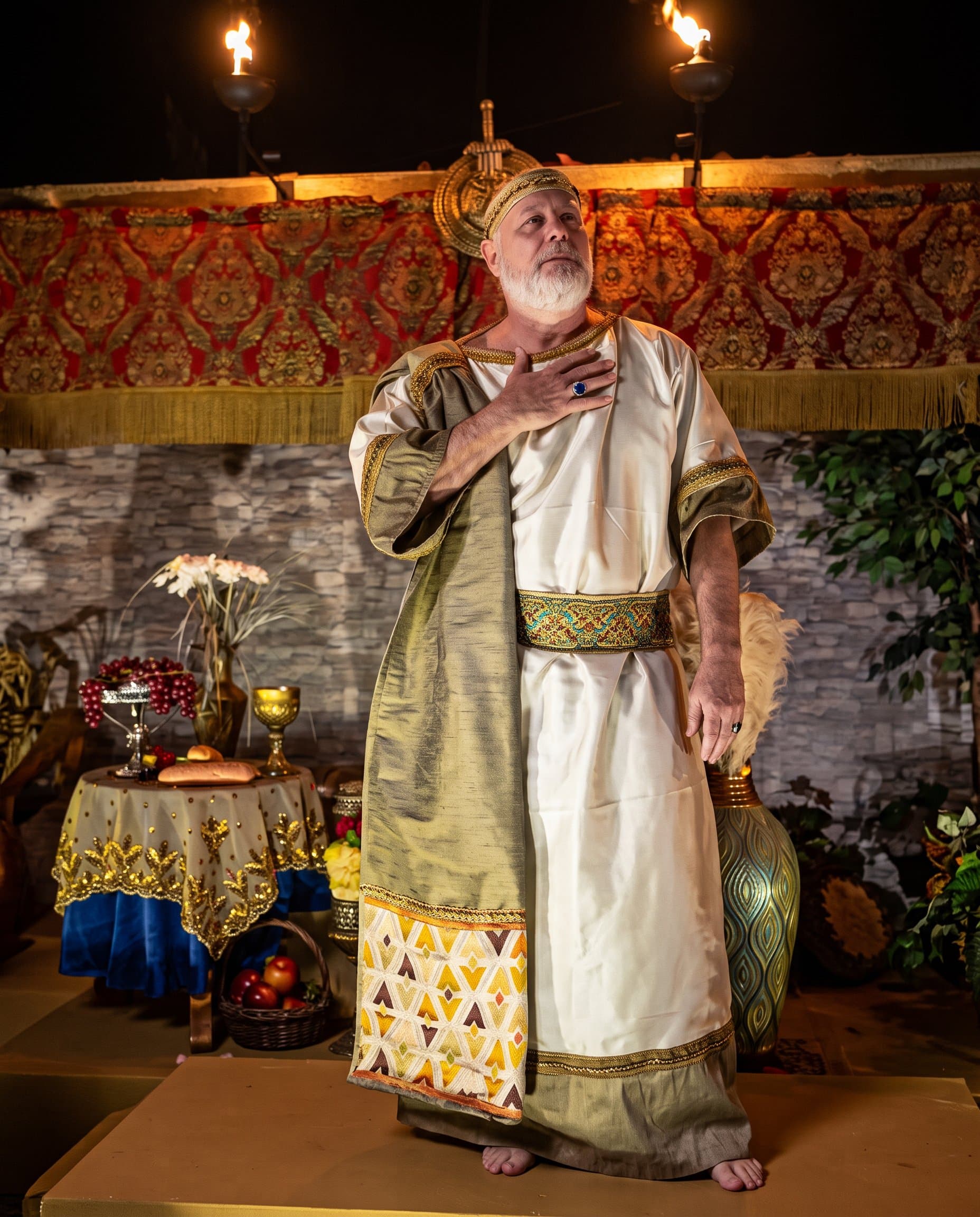 A wise man in a gold crown and blue robe holding a gift